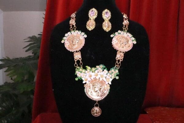 A necklace and earrings set with flowers on them.