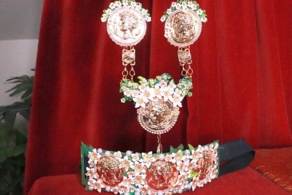 A tiara, crown and necklace set with flowers.
