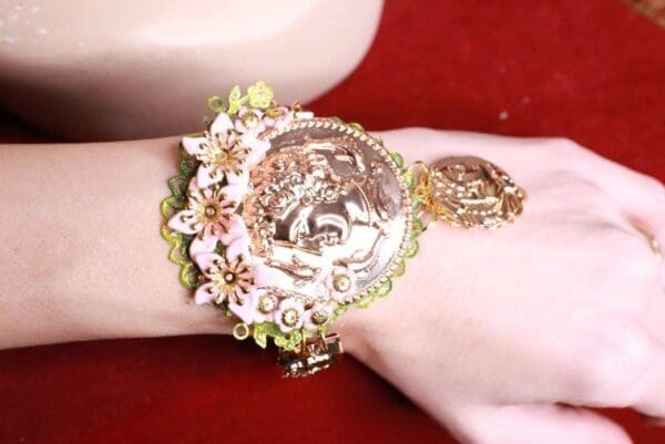 A woman wearing a bracelet with flowers on it.