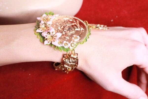 A woman 's arm with a bracelet on her wrist.