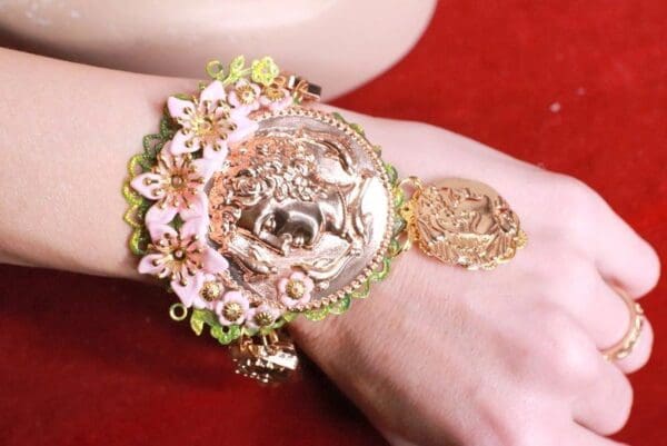 A woman 's arm with a bracelet on it
