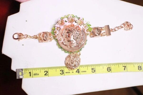 A ruler and some gold jewelry on top of it