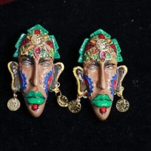 A pair of colorful face earrings with gold coins.