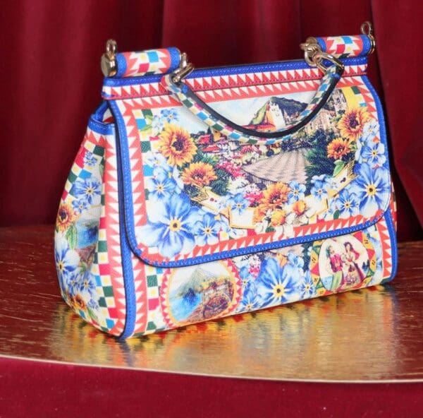 A colorful purse sitting on top of a table.