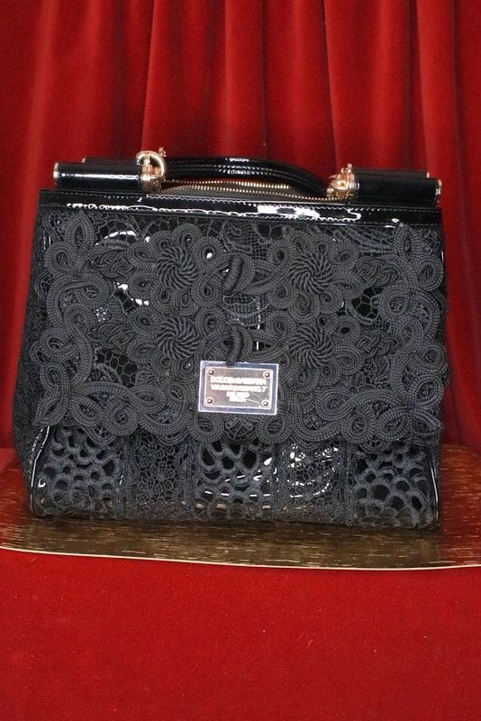 A black purse sitting on top of a table.