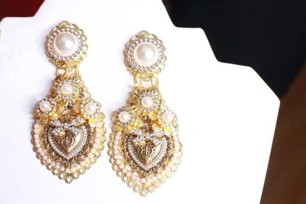 A pair of earrings with pearls and gold