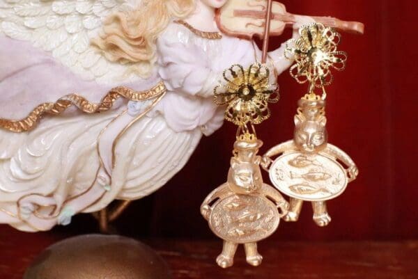 A pair of earrings hanging from the side of a statue.