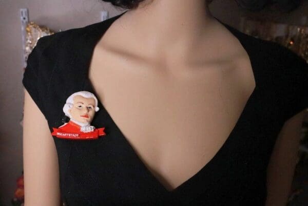 A woman wearing a black shirt and red sweater.