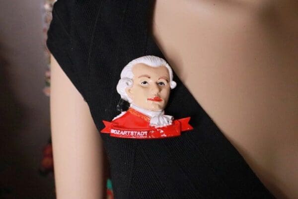 A close up of the head of a man wearing a red shirt