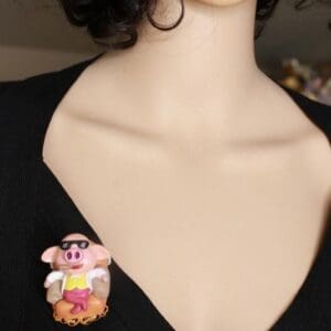 A woman wearing black shirt and pink hair with a cartoon character on it.