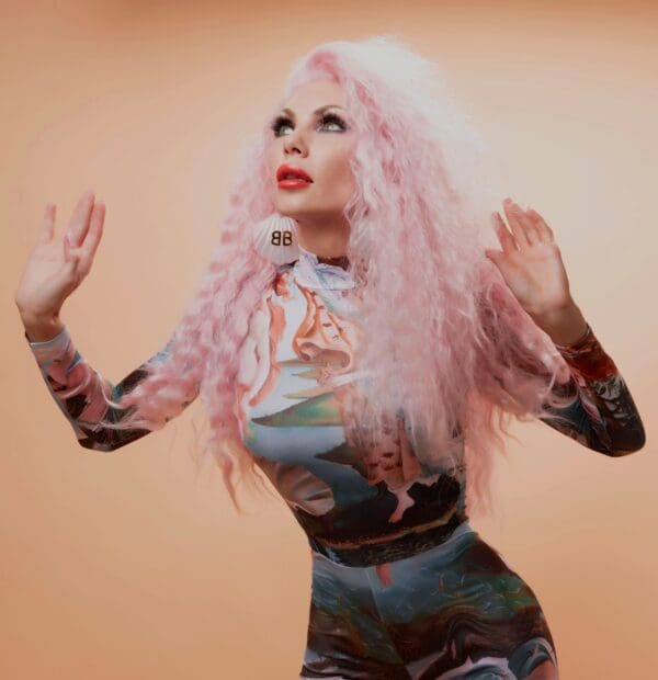 A woman with pink hair and a dress