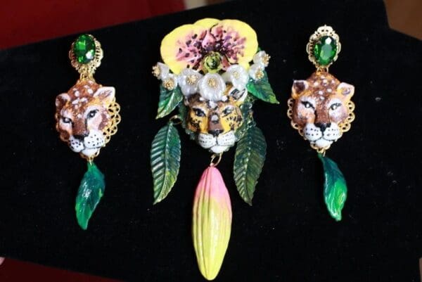 A set of three earrings and one brooch.