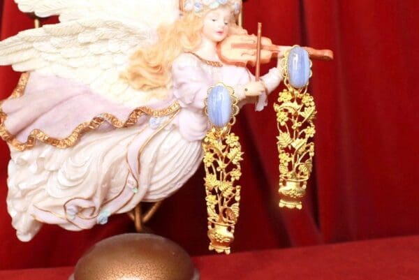 A close up of a doll and earrings