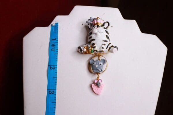 A white and black cat with a heart on it's back.