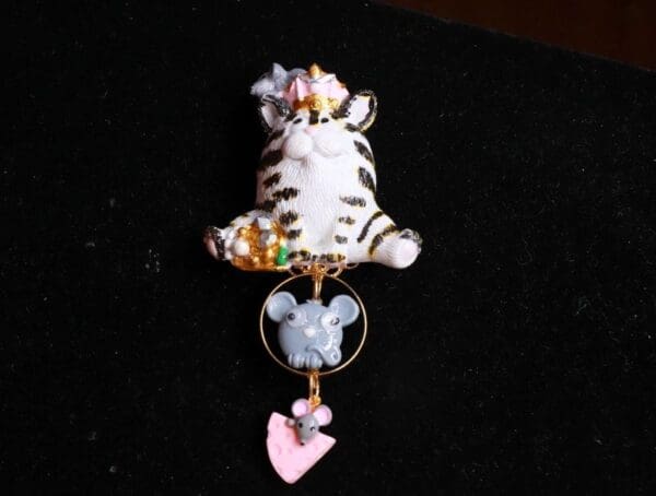 A cat with a heart hanging from its tail.