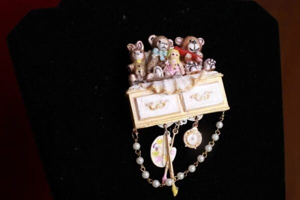 A close up of a brooch with many different bears