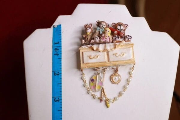 A small piece of jewelry is shown on the table.