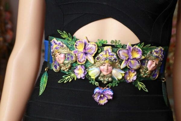 A woman wearing a black dress with purple flowers.