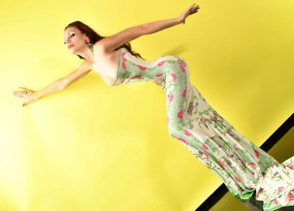 A woman in a floral dress posing for the camera.