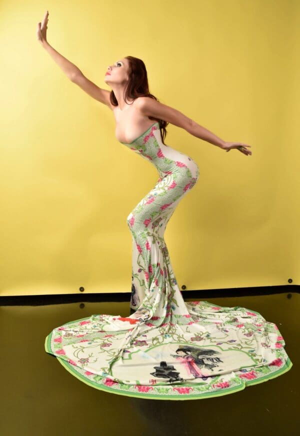 A woman in a dress is standing on the floor