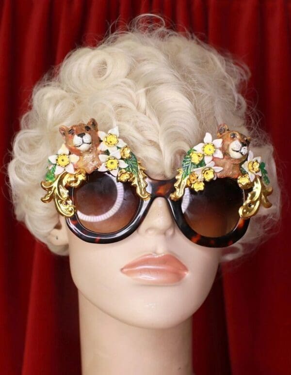 A blonde wig with some glasses and flowers on it