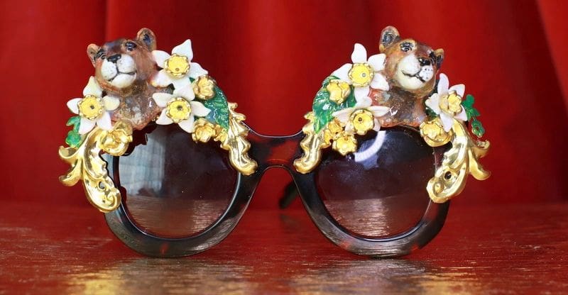 A pair of sunglasses with bears and flowers on them.