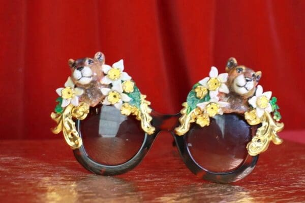 A pair of sunglasses with flowers and bears on them.