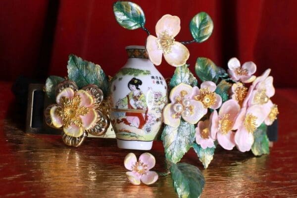A vase with flowers on top of a table.