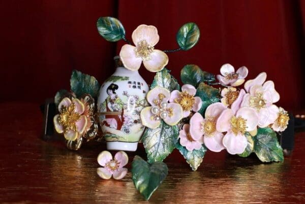 A vase with flowers and leaves on the table
