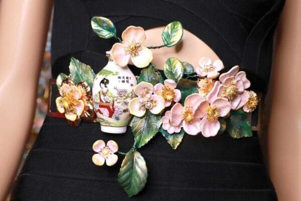 A close up of a flower arrangement on the wall