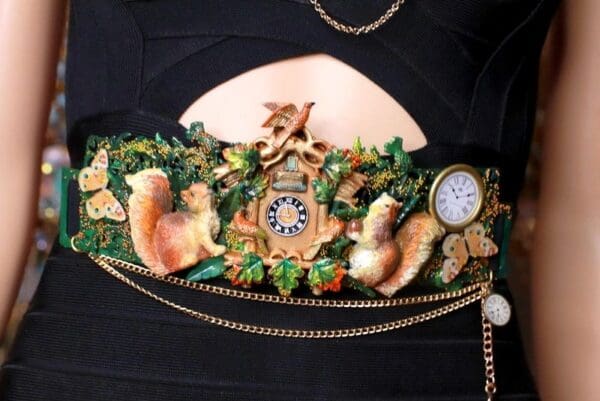 A close up of the front of a purse with a clock
