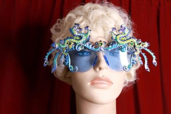 A mannequin wearing blue glasses with sea creatures on them.