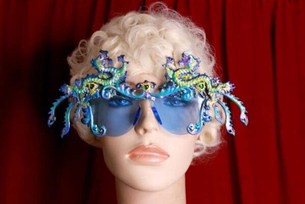 A mannequin wearing blue glasses with octopus decorations.