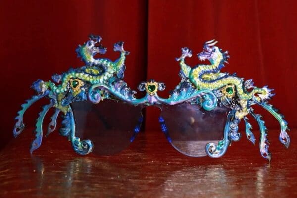 A pair of glasses with dragon designs on them.