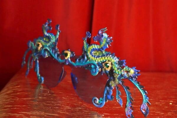 A pair of blue and yellow glasses sitting on top of a table.