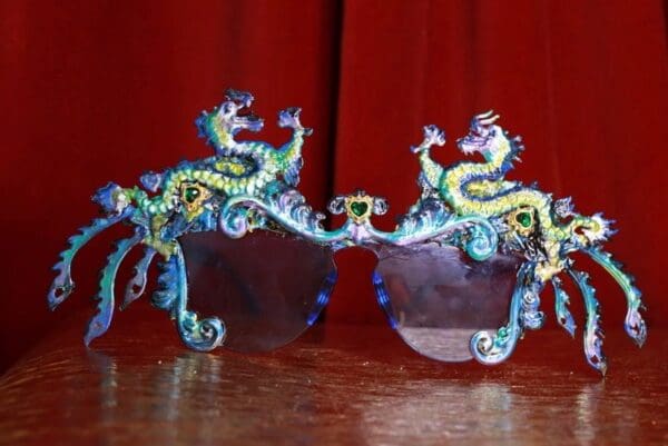 A pair of glasses with dragon heads on them.