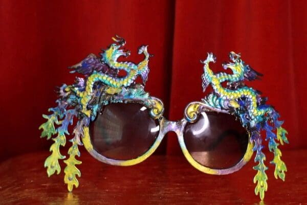 A pair of sunglasses with dragon 's on them.