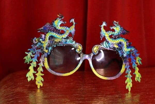 A pair of sunglasses with dragon 's on them.