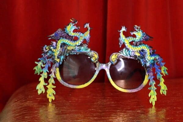 A pair of sunglasses with dragon design on them.