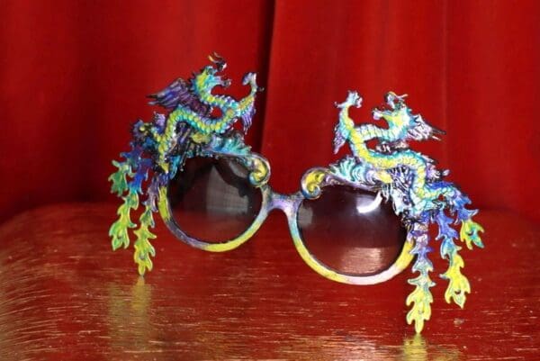 A pair of glasses with dragon design on them.