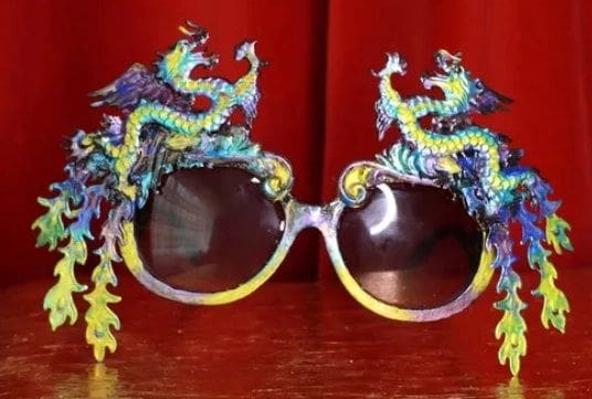 A pair of sunglasses with dragon 's on them.