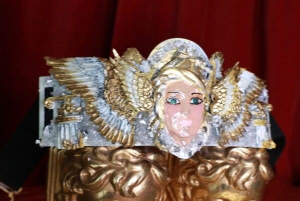 A close up of the face on a statue