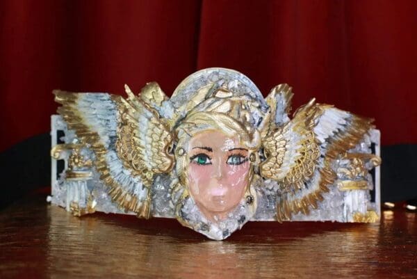 A close up of a mask with feathers on it