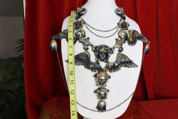 A necklace with a skull and bat design on it.