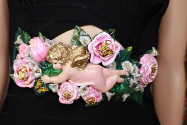 A close up of the pink and gold angel decoration