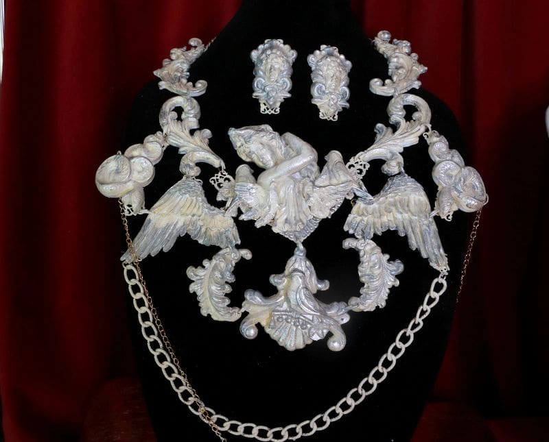 A necklace and earrings set with white lace.