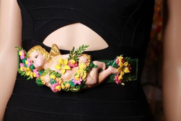 A close up of a doll with flowers on it