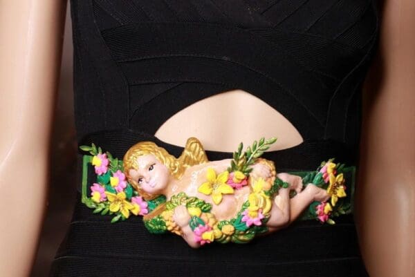 A baby angel with flowers on it's head and wings.