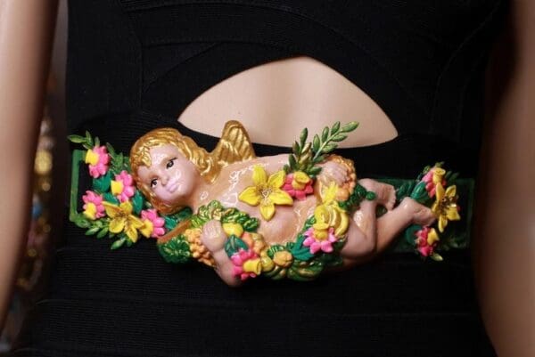 A baby angel with flowers on it's back.
