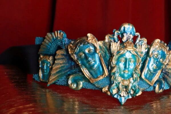 A group of blue and gold statues sitting on top of a table.
